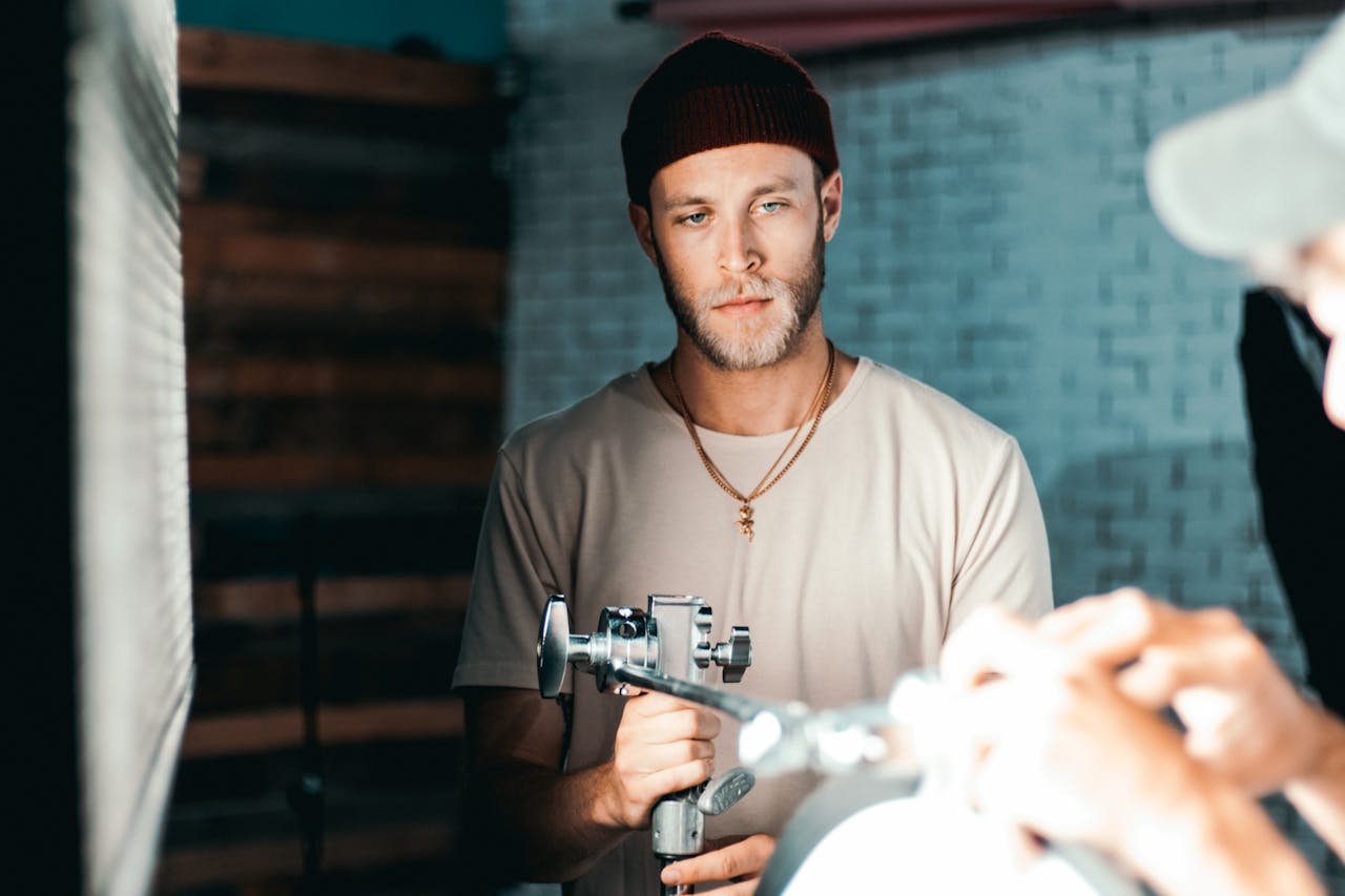 Professional filmmaker holding camera equipment in a studio setting.